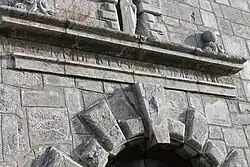 Details of the portal with Latin inscription.