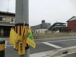 Box of yellow pedestrian crossing flags in Japan, 2013