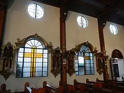 Side wall with the stained windows and religious images