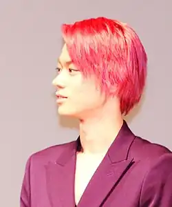 Masaki Suda in red-dyed hair, attending the 2015 Busan International Film Festival.