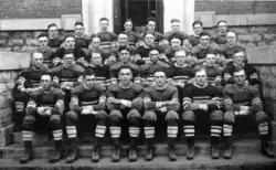 A team of football players seated