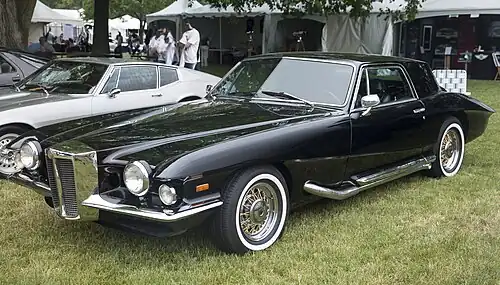 A black Stutz Blackhawk automobile parked on grass.