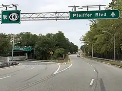 A four-lane road at dusk approaching a large split