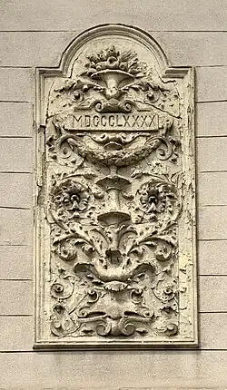 Arabesque with foliage spirals and a rectangular cartouche with the year when the house was built, on a corner of Strada General H.M. Berthelot no. 52, Bucharest, unknown architect, 1890