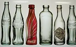 Numerous historical Coke bottles