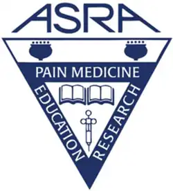Triangular symbol with "ASRA" above and containing books and a syringe, with the outline of the triangle reading "Pain Medicine", "Education", and "Research"