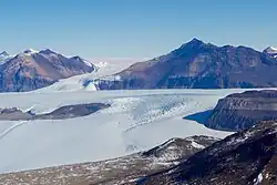 A glacier surrounded by barren mountains in McMurdo Dry Valleys, Antarctica