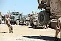 A U.S. Marine steadies an MRAP vehicle as it's lifted at FOB Edinburgh, June 20, 2011.