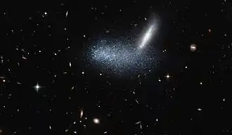 Irregular dwarf galaxy PGC 16389 covers its neighboring galaxy APMBGC 252+125-117.[22]
