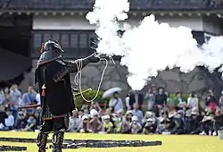 A member of the Matsumoto Castle Gun Corps firing a tan-zutsu.