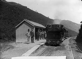 A train in Abergynolwyn station, with the original station building, looking east circa 1885.