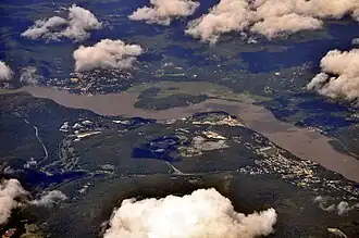 Aerial view from southwest includes the Hudson River, Highland Falls (on right), Cold Spring (on left) across the river in Putnam County