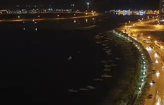 Night view of the boats docked to the east shoreline of Al-Khan Lagoon
