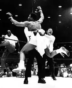 Ali lifted up by his team after being declared the victor