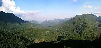 Panoramic view of hillsides densely covered in green forest