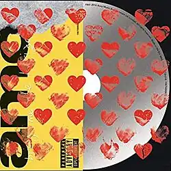 A blank CD decorated with red hearts in a plastic bag, with the word "Amo" and a barcode on a label next to it.