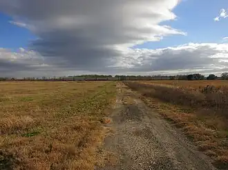 Duke Road is fenced off where it crosses Houston Southwest Airport property. Duke was located just beyond the BNSF Railway freight train in the distance.