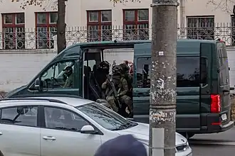 A minivan with armed troopers
