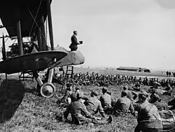 An army chaplain conducts a service from the cockpit of an aeroplane, France, during World War I