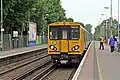 A Merseyrail Class 507 waits at the station.