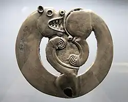Curled-up feline animal from Arzhan-1, circa 800 BCE.[17][18] This is the earliest known of a common animal art design.