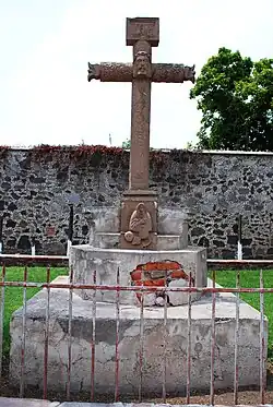 An atrium cross in Acolman, an anthropomorphized stone cross with Jesus at its center.