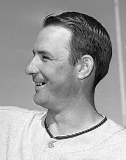 A man in a light baseball uniform