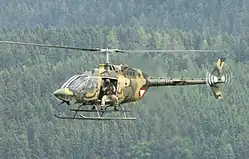 A soldier of the Jagdkommando on a Bell OH-58 Kiowa
