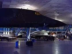 The nose section of a B-1A on display with outline of the ejection capsule denoted