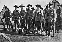 A group of standing men wearing World War I-era military uniforms