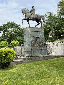 An equestrian statue of Marshal Bagramyan in Yerevan's Baghramyan Avenue, standing in front of the American University of Armenia