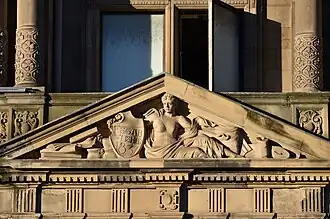 Classical female nude holding a shield with the date of the establishment of Jenners, door pediment, main entrance, Princes Street façade