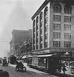 H. Jevne & Co. Building (right) at southwest corner of 6th and Broadway (Los Angeles), c.1915. Bullock's department store at back left