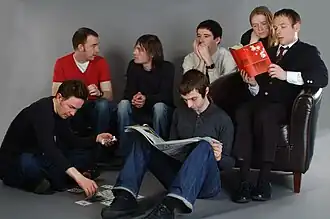 Members of Belle and Sebastian, pictured sometime between 2001 and 2006. Left to right: Mick Cooke, Richard Colburn, Bobby Kildea, Chris Geddes, Stevie Jackson, Sarah Martin, Stuart Murdoch