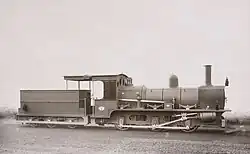 Old photograph of a steam locomotive on flat track