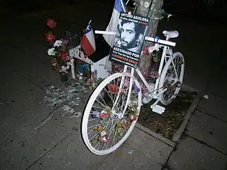 Ghost bike or "Bicianimita" in Santiago, Chile, with a traditional small house for the soul, commemorating Arturo Aguilera, killed 2012