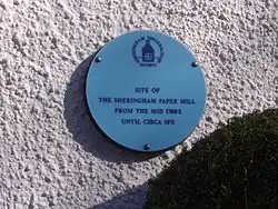 The Blue Plaque on the wall of a Cottage in Beeston Road, Sheringham, marks the location of Sheringham watermill (Paper).