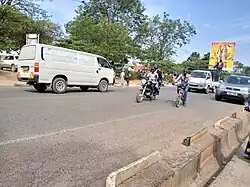 Boda, car and bicycle moving on Arua Main Street