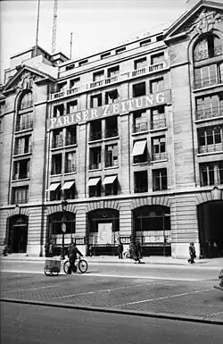 A black and white image of a Parisian building