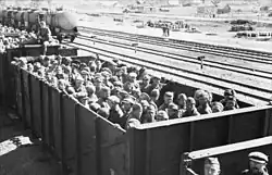 Hopper cars full of standing prisoners of war