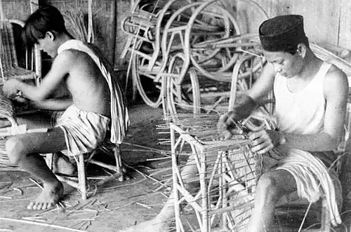 Indonesians making rattan furniture, c. 1948