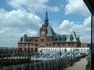 Communipaw Terminal, a historic building, with the dock in foreground provides ferry transport to Ellis Island and Statue of Liberty