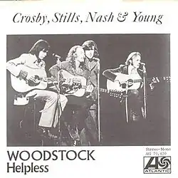 A single sleeve with the text "Crosby, Stills, Nash & Young" printed at the top. Immediately below is an image of all 4 members performing live. Beneath that image, in the bottom left, are the names of the 2 songs on the single: 'WOODSTOCK', in all-caps and larger font (to signify it is the A-Side), and 'Helpless', in title-case and smaller font. In the bottom right, there is the Atlantic Records logo as well as the text 'Stereo-Mono' and 'Atl. 70.430' (its catalog number). The entire sleeve is printed in monochrome black-and-white.