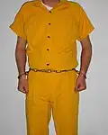 Inmate in belly chain with the handcuffs directly attached to the chain at the sides