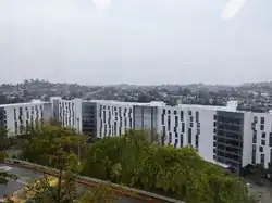 A window photograph overlooking the Southern Village, a complex of white buildings, of the Student Housing East buildings.