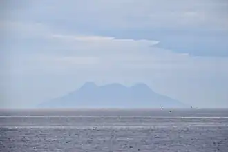 Silhouette of Mt. Timpoong (L) and Mt. Mambajao (R), the highest peaks of the largest mountain in Camiguin, as seen from the north, across Bohol Sea