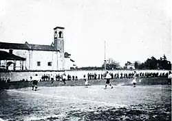 A black and white photo of a football pitch during a match