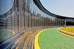 A part of the memorial wall with man standing before it.