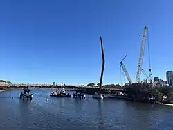 Under-construction cable-stayed bridge across a river with one tower
