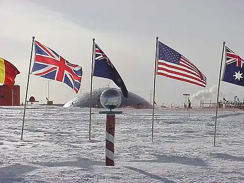 Ceremonial South Pole in 1999 (the dome in the background was dismantled in 2009–2010).
